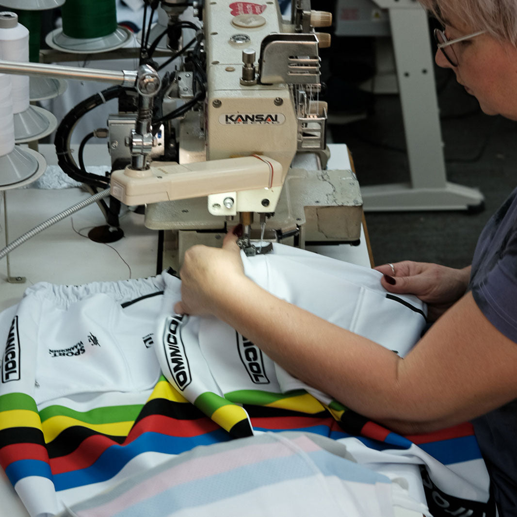 A woman is sewing cycling apparel.