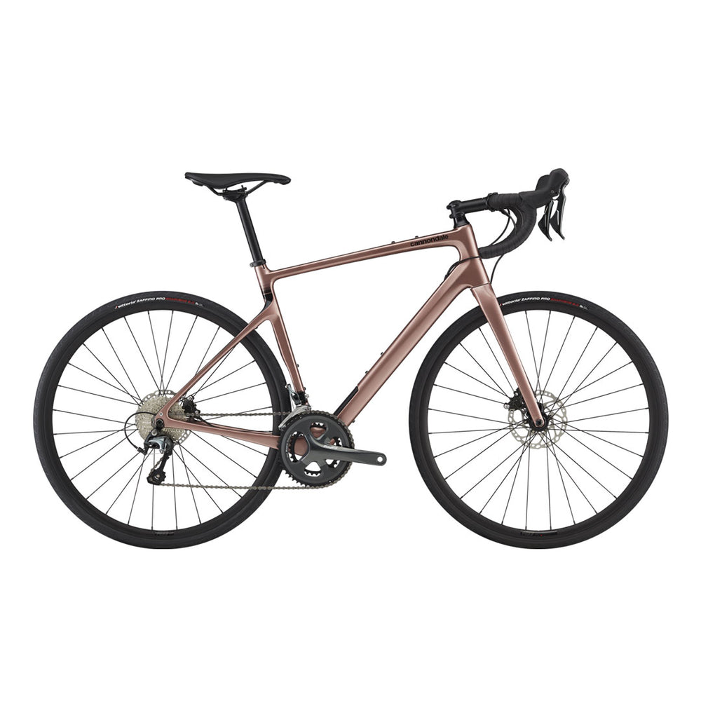 A side profile shot of the Cannondale Synapse Carbon 4 road bike in Rose Gold.